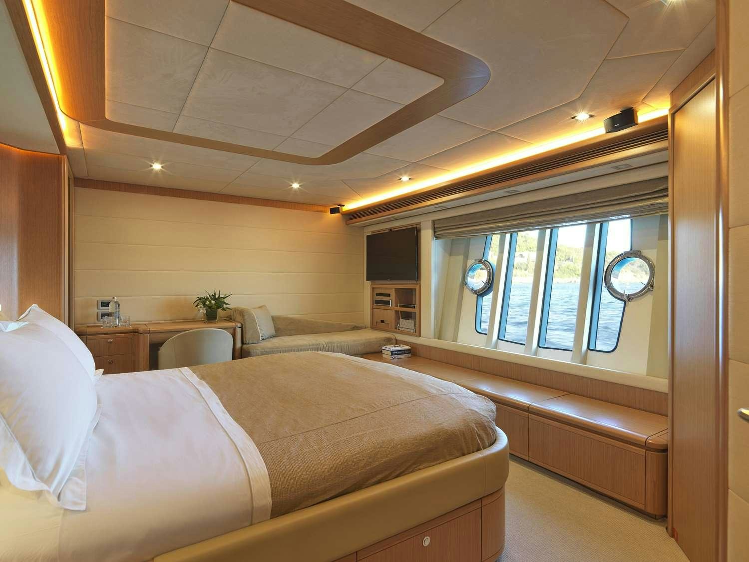 a room with a bed and a window aboard JULIE M Yacht for Charter