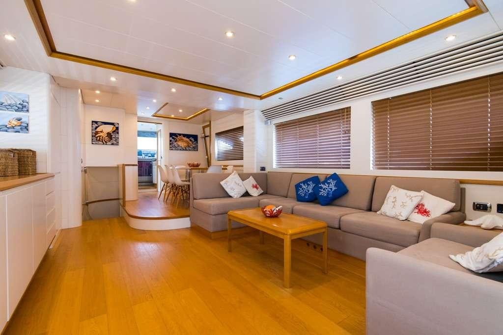 a living room with a couch and a table aboard RIVIERA Yacht for Charter