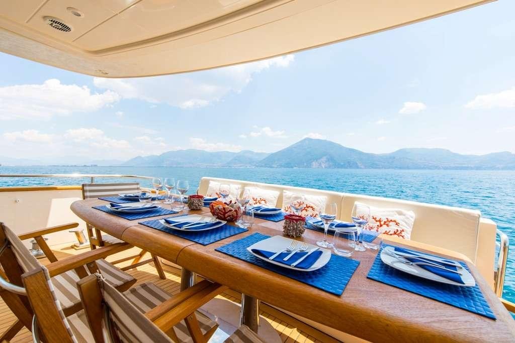 a table set for a meal on the beach aboard RIVIERA Yacht for Charter