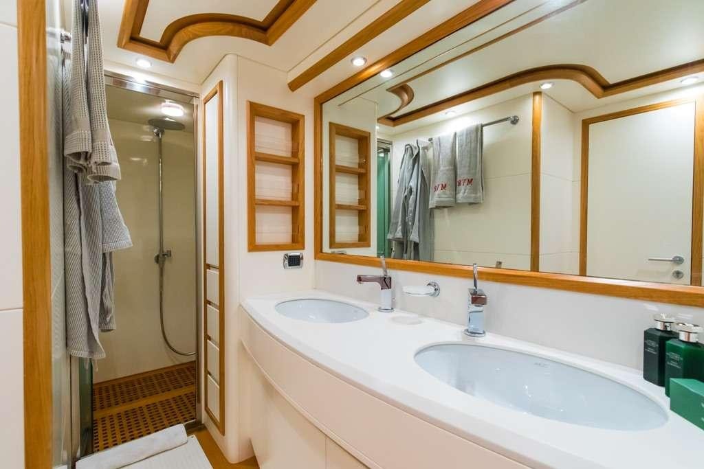 a bathroom with two sinks and a large mirror aboard RIVIERA Yacht for Charter