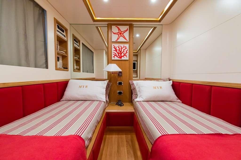 a couple of beds in a hotel room aboard RIVIERA Yacht for Charter