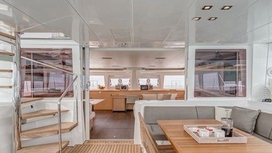 a room with a couch and a table aboard O CAT Yacht for Charter