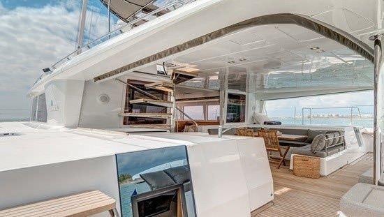 a room with a large white boat aboard O CAT Yacht for Charter