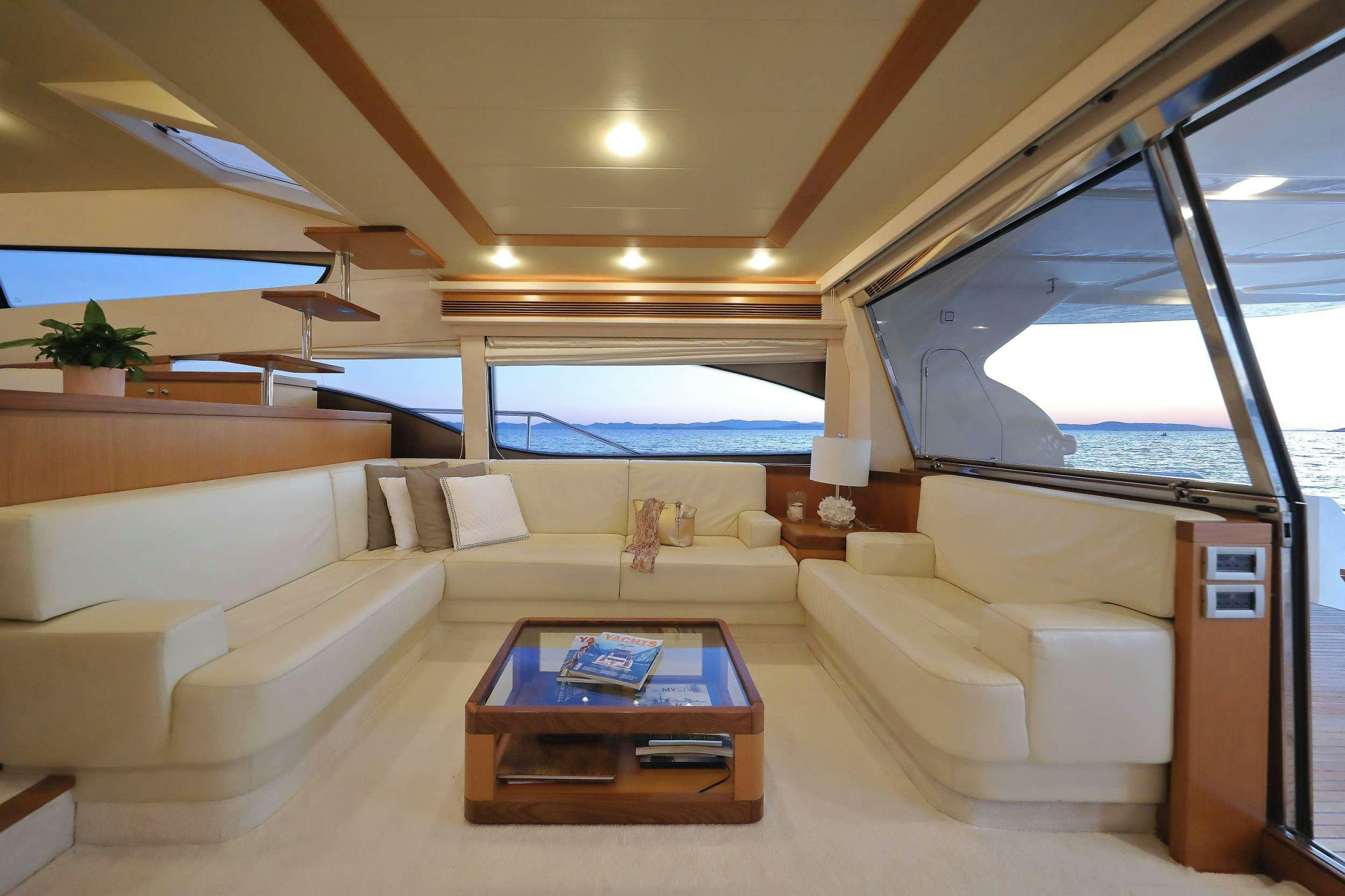 a living room with a large window aboard dominique Yacht for Charter