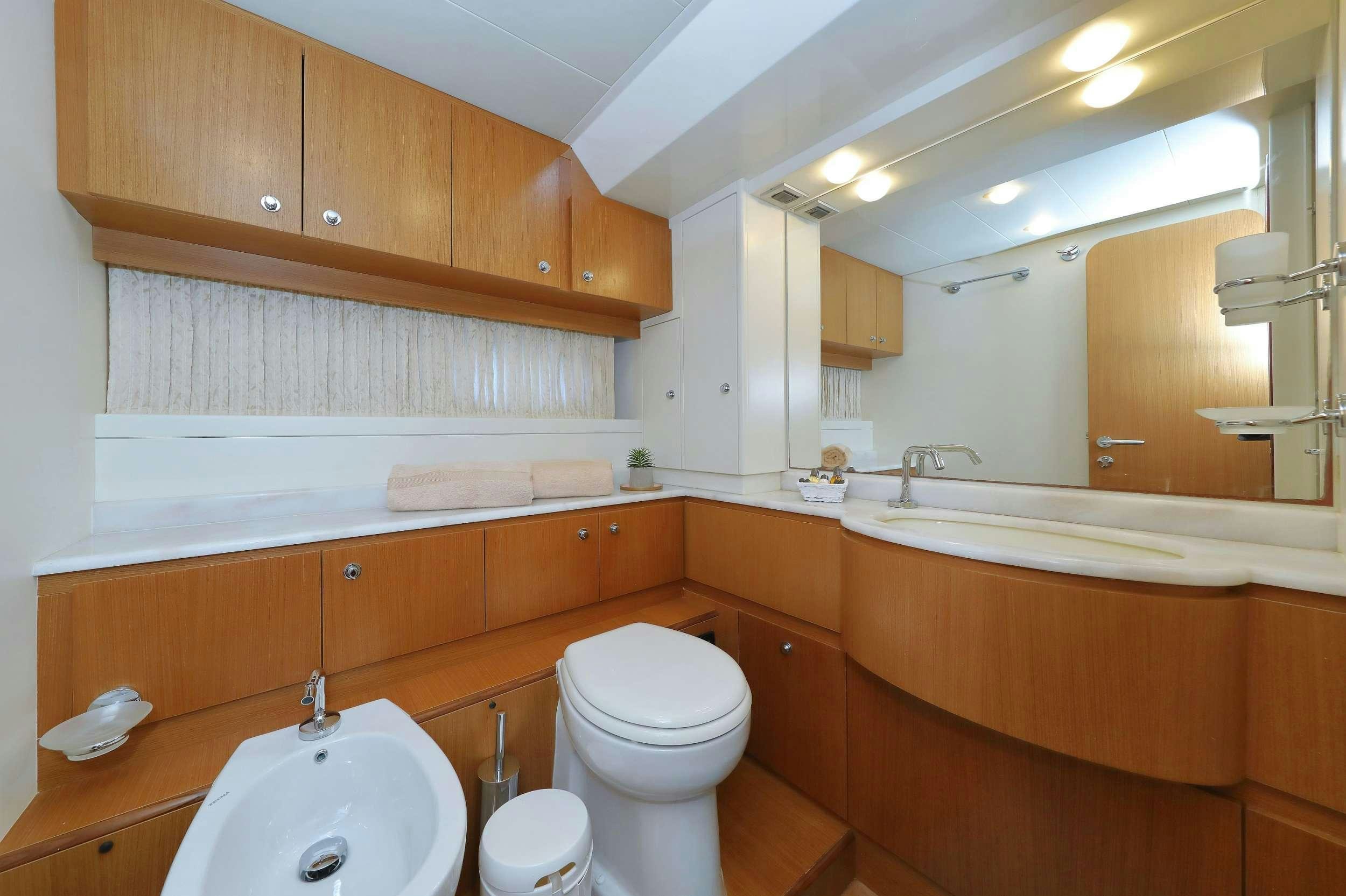a bathroom with a toilet sink and a bathtub aboard dominique Yacht for Charter