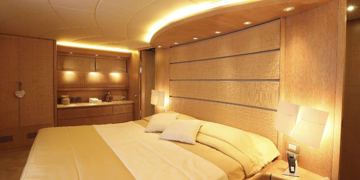 a room with a bed and a desk aboard IF Yacht for Charter