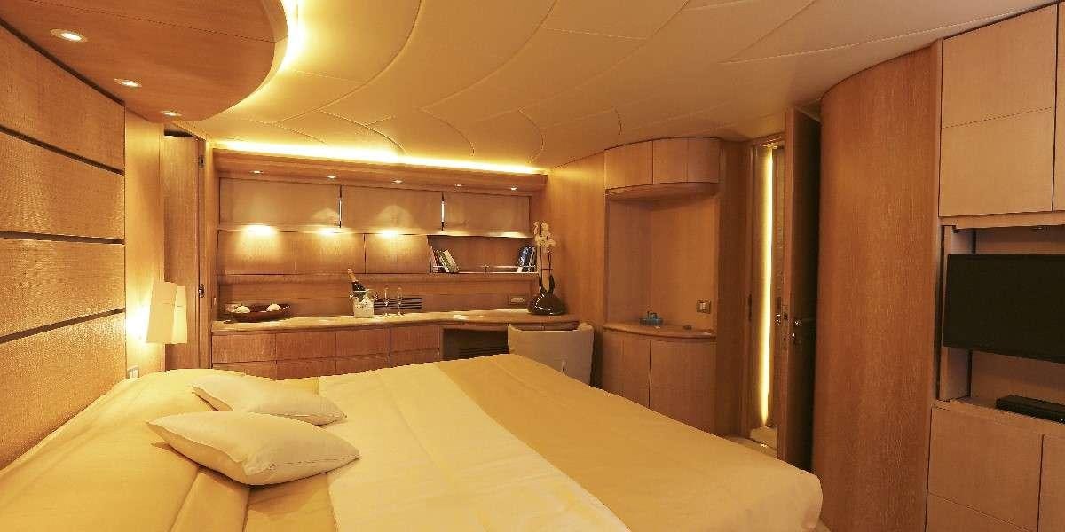 a room with a bed and cabinets aboard IF Yacht for Charter