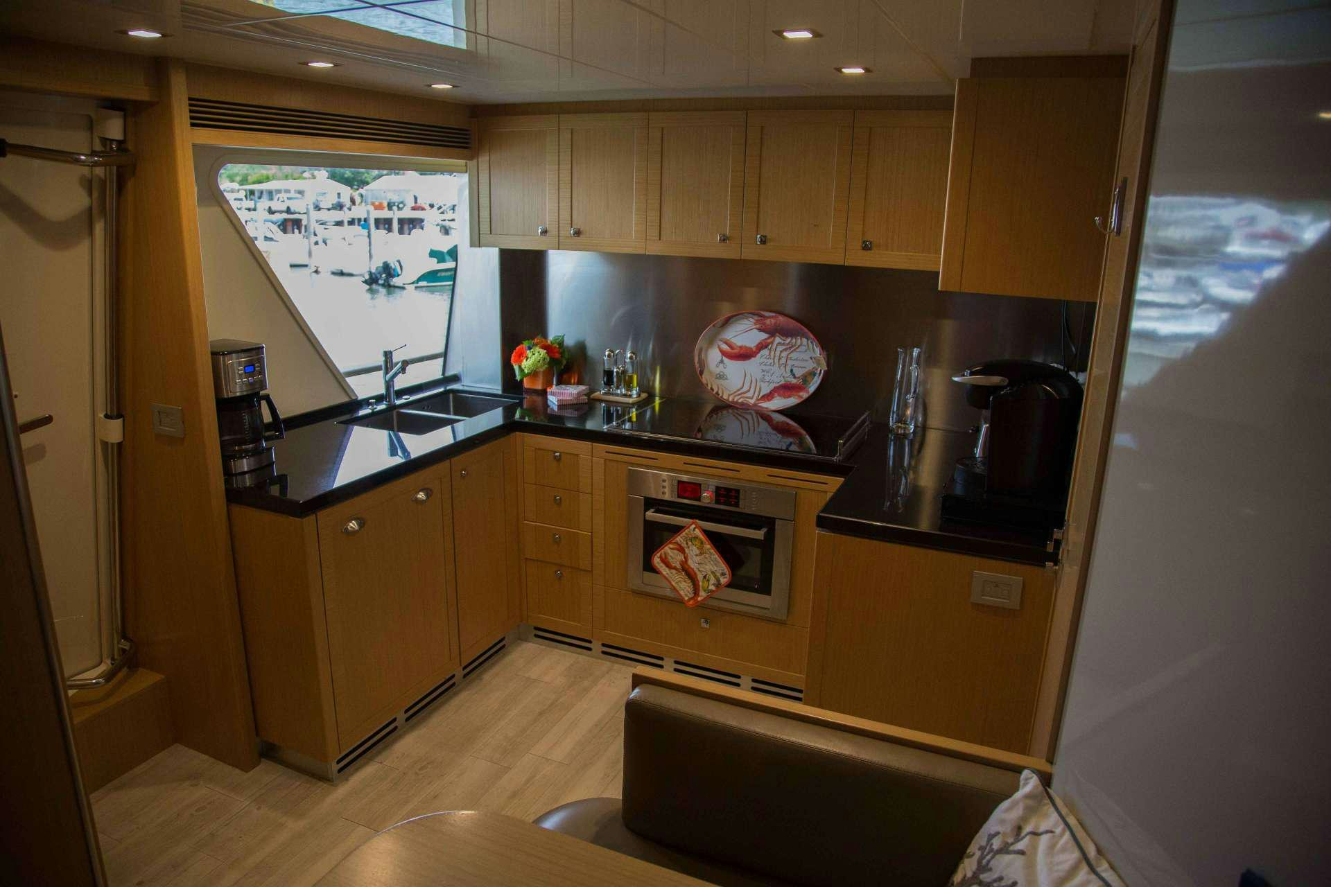 a kitchen with a stove and oven aboard SLAINTE III Yacht for Charter