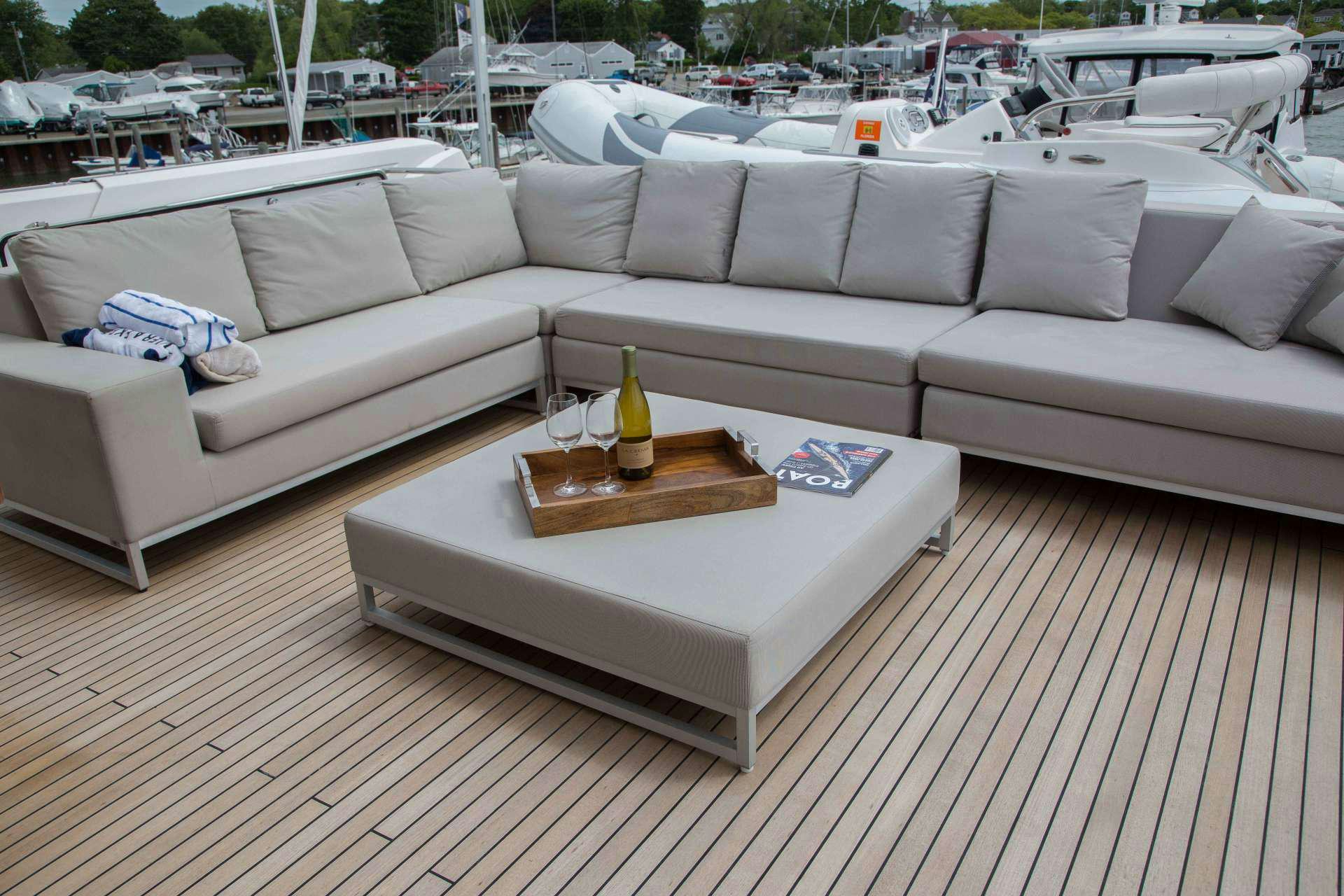 a couch with a glass table on it aboard SLAINTE III Yacht for Charter