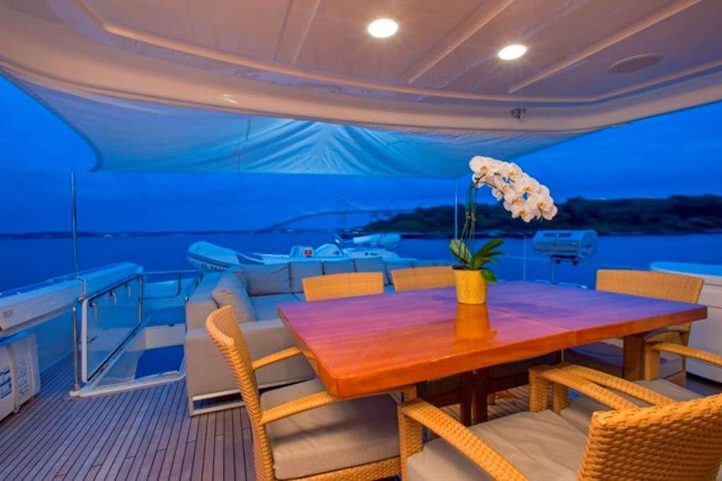 a room with a table and chairs aboard SLAINTE III Yacht for Charter