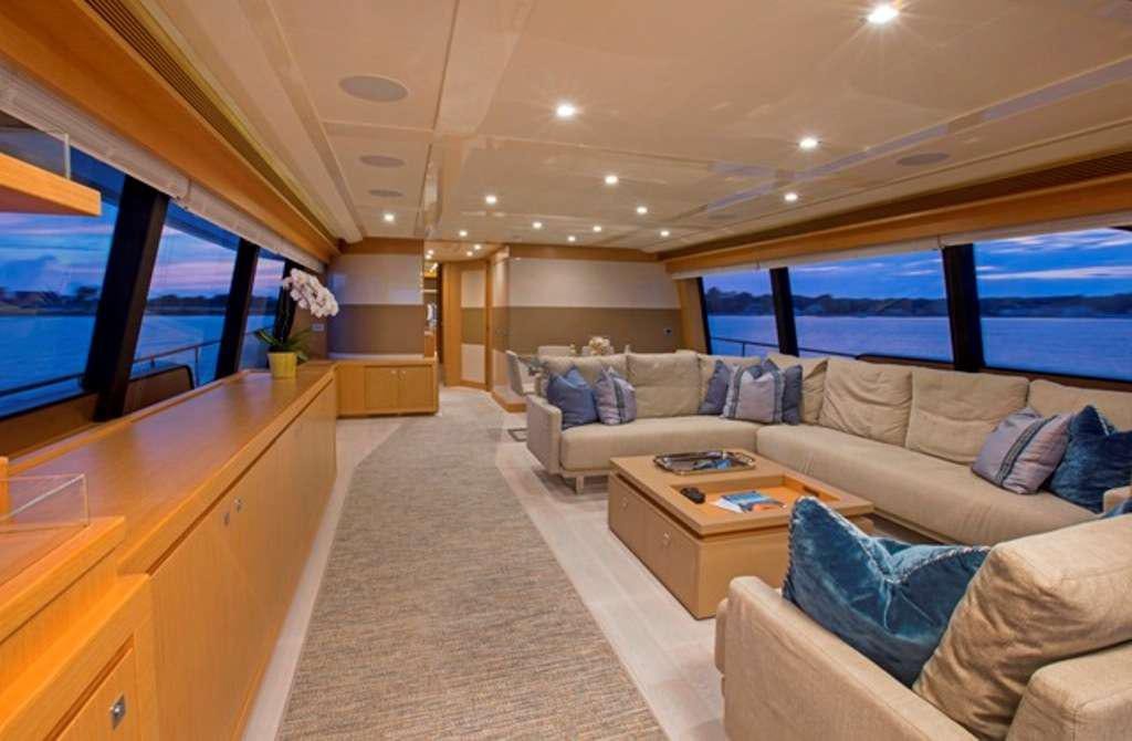 a living room with a large window aboard SLAINTE III Yacht for Charter