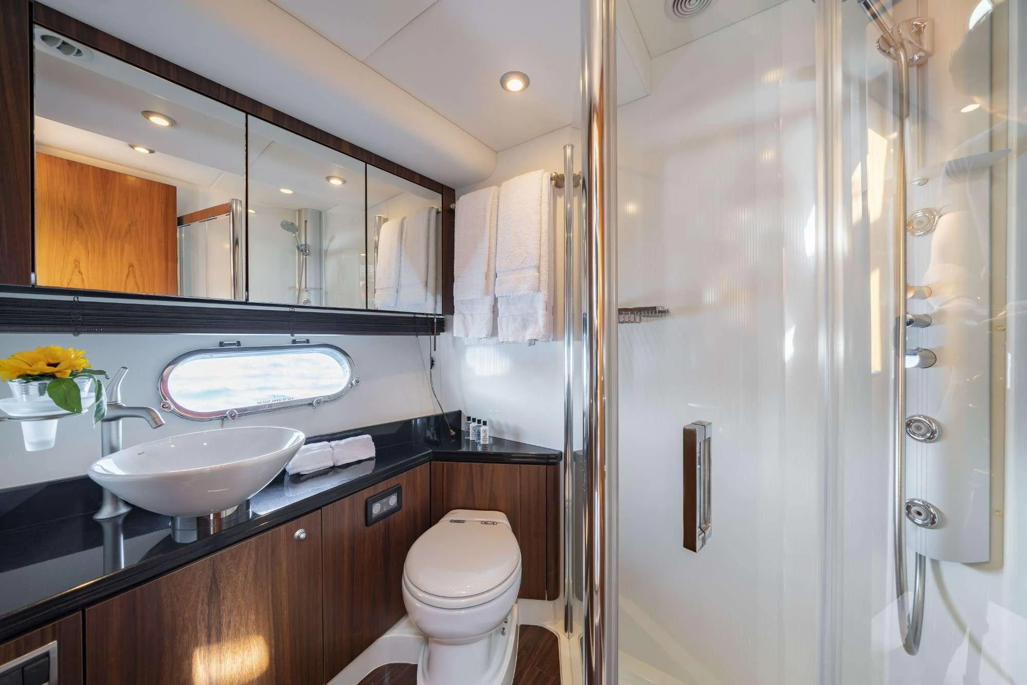 a bathroom with a glass shower aboard LAZY P Yacht for Charter