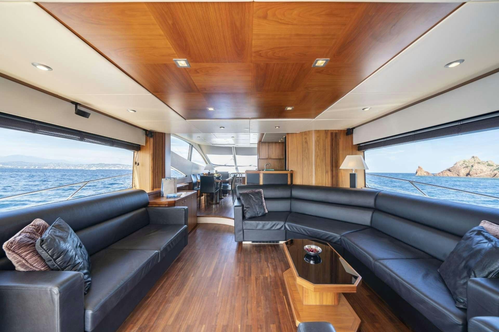 a living room with a couch and a large window aboard LAZY P Yacht for Charter