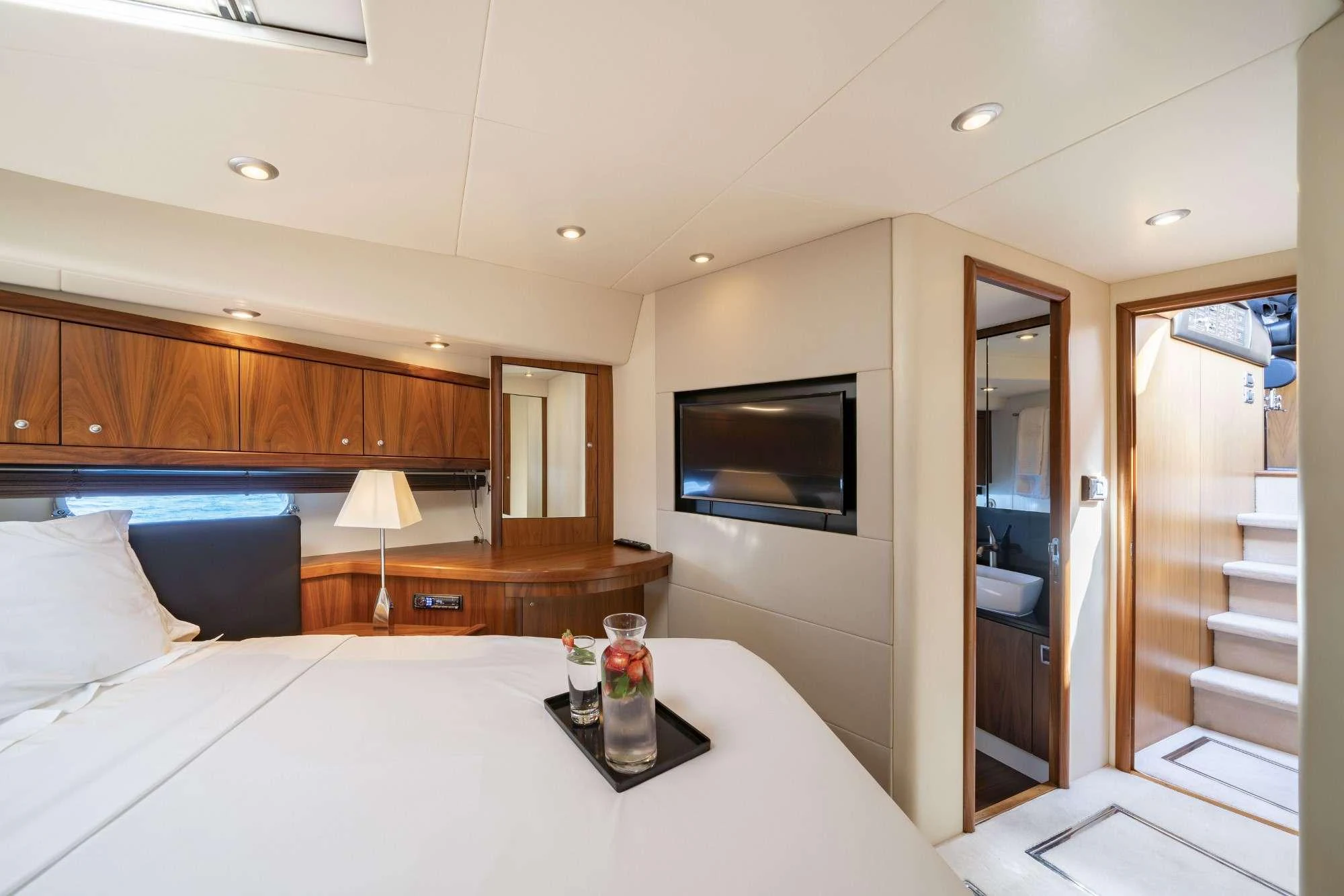 a hotel room with a bed and a television aboard LAZY P Yacht for Charter