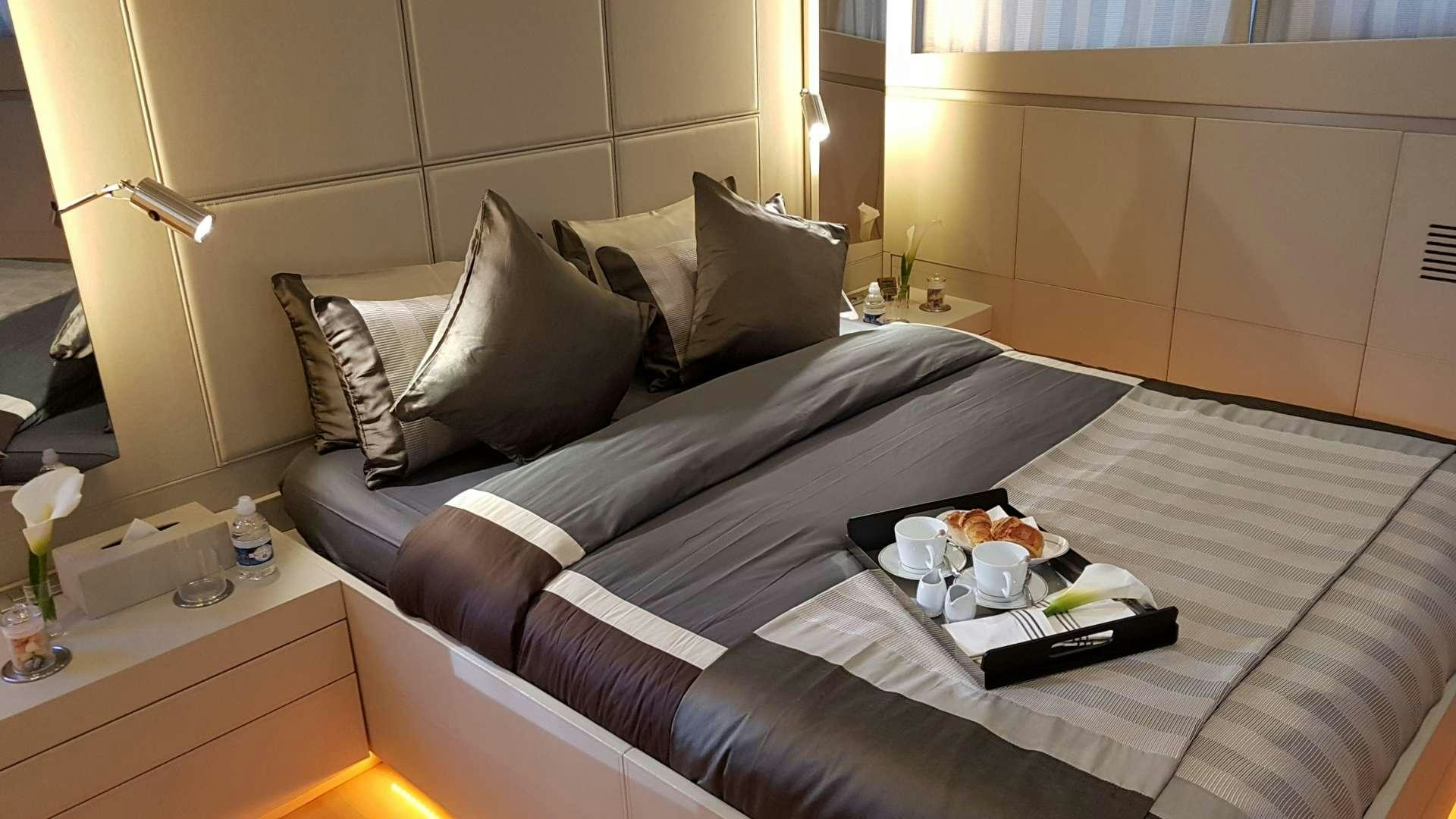 a couch with pillows and blankets aboard TEMPEST WS Yacht for Charter