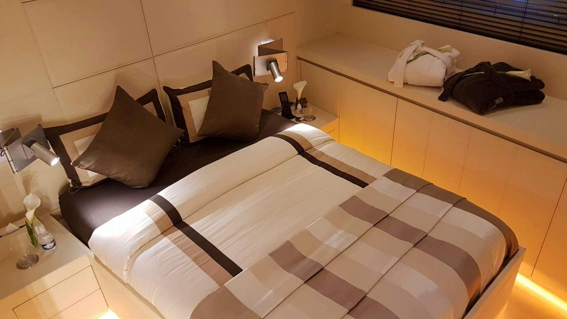 a bed with white sheets aboard TEMPEST WS Yacht for Charter