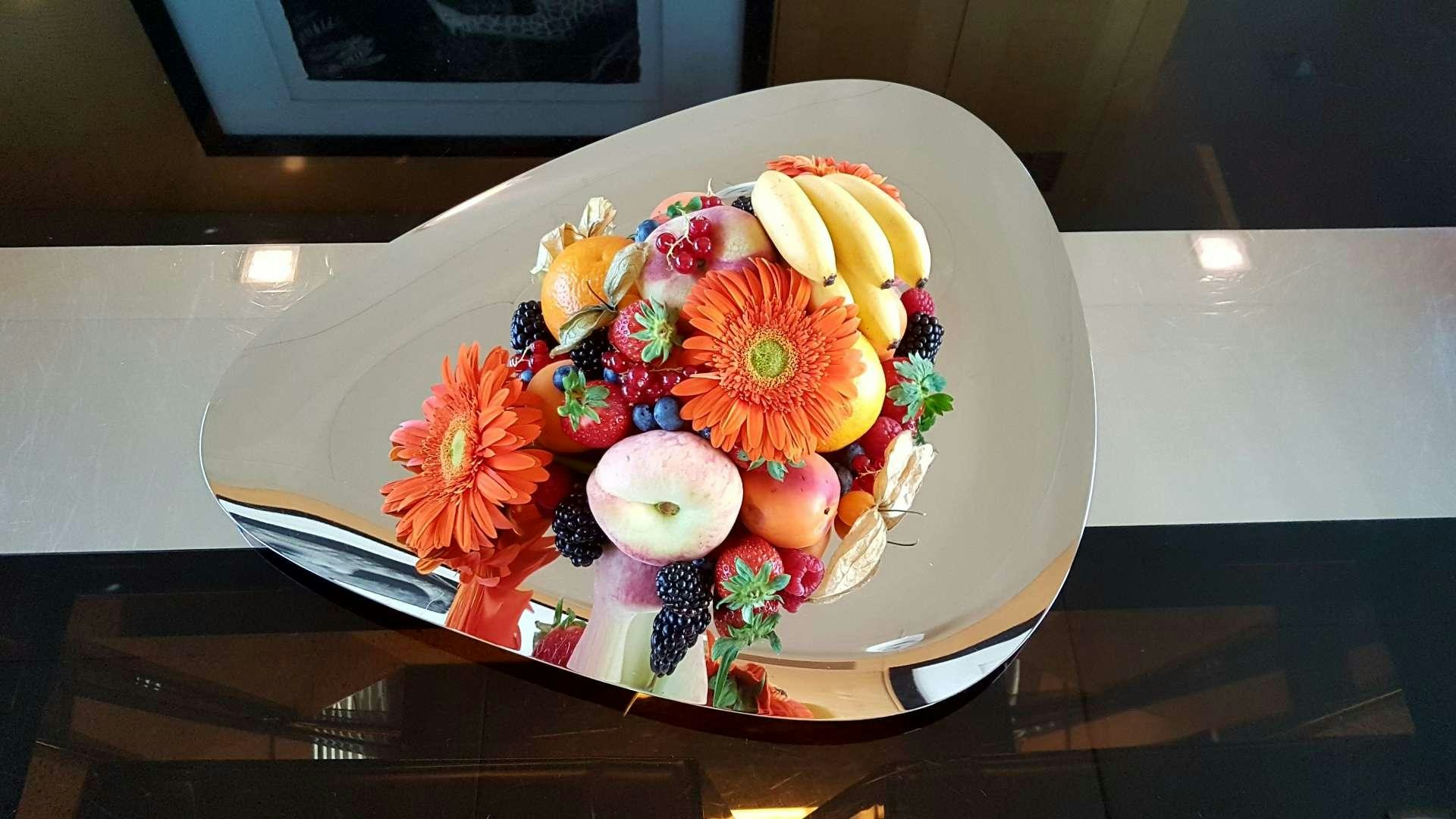 a plate of flowers and fruit aboard TEMPEST WS Yacht for Charter