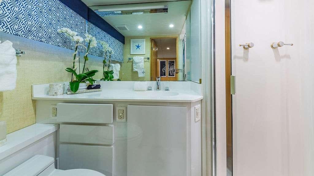 a bathroom with a sink and a mirror aboard ALEXANDRA JANE Yacht for Charter