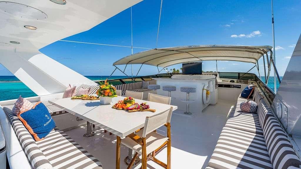 a large white boat on a body of water aboard ALEXANDRA JANE Yacht for Charter