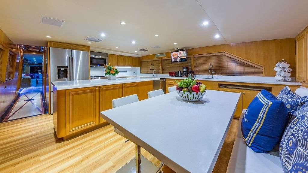 a large kitchen with a large table aboard ALEXANDRA JANE Yacht for Charter