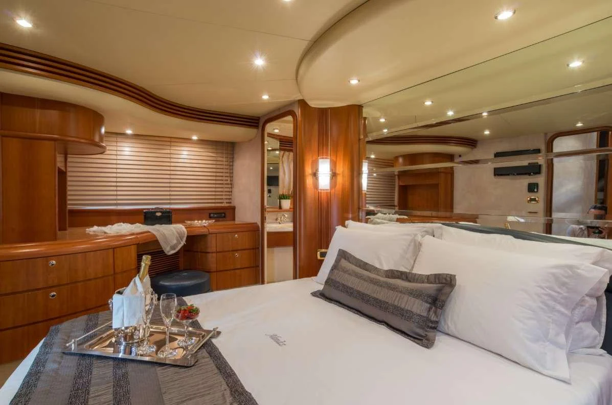 a bed with white sheets and pillows aboard ALMAZ Yacht for Charter