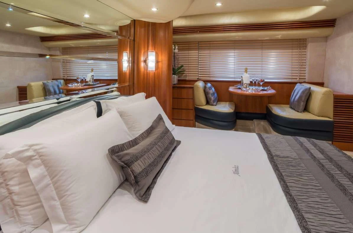 a room with a bed and a couch aboard ALMAZ Yacht for Charter