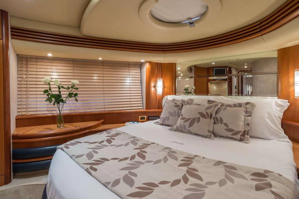a bed with white sheets and pillows aboard ALMAZ Yacht for Charter