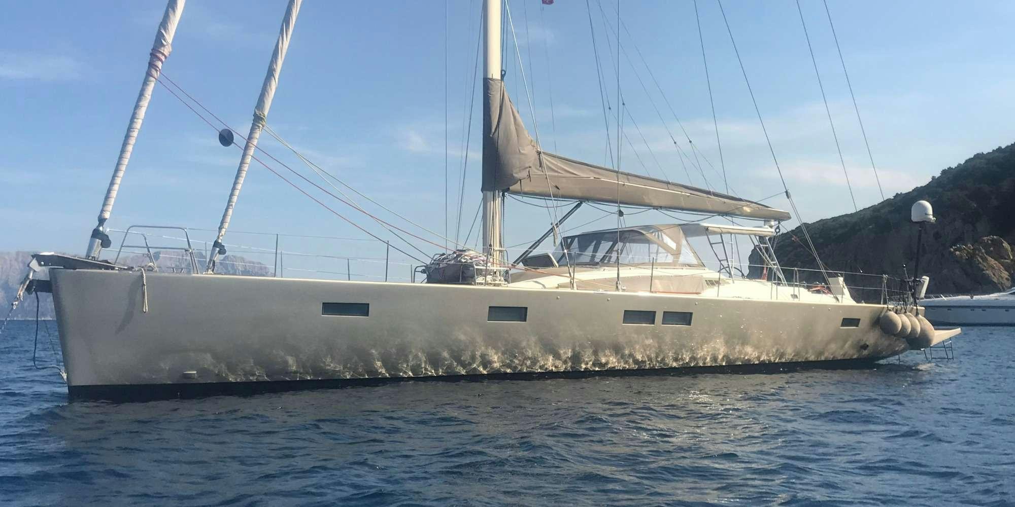 a large white boat in the water aboard ICHTUS Yacht for Charter