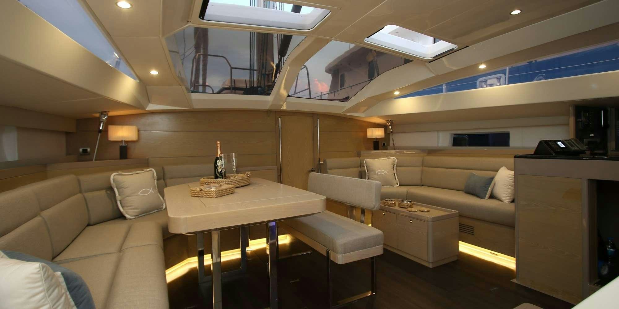 a room with a couch and a table aboard ICHTUS Yacht for Charter
