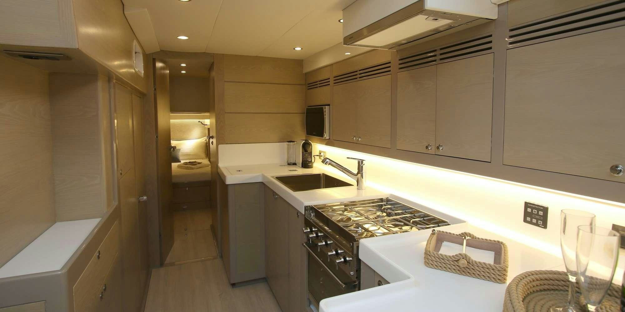 a kitchen with white cabinets aboard ICHTUS Yacht for Charter