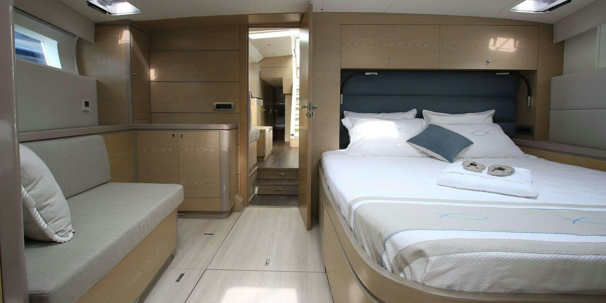 a room with a bed and a couch aboard ICHTUS Yacht for Charter