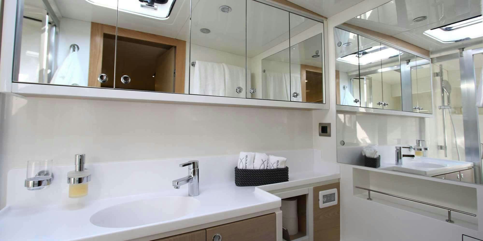a bathroom with a large mirror aboard ICHTUS Yacht for Charter