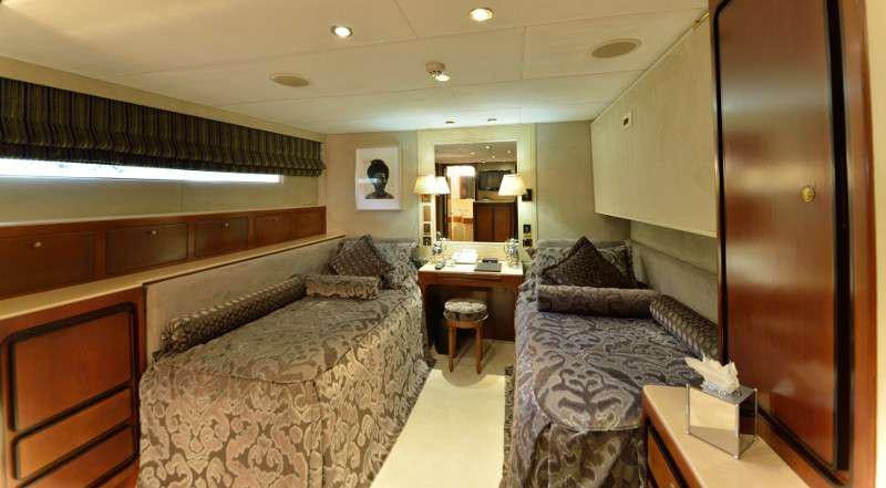 a bedroom with a bed and a mirror aboard THE MERCY BOYS Yacht for Charter