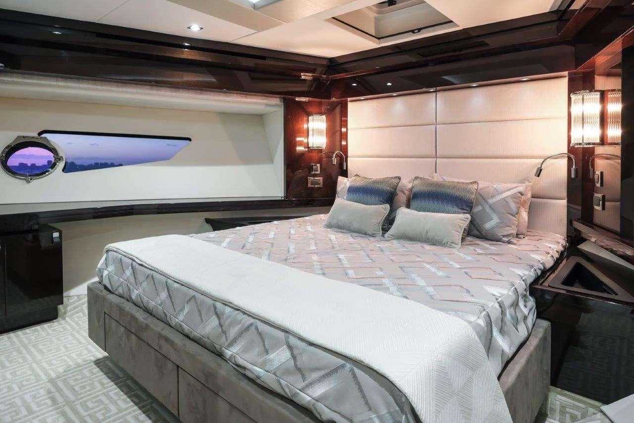 a room with a bed and a television aboard GOLDEN OURS Yacht for Charter