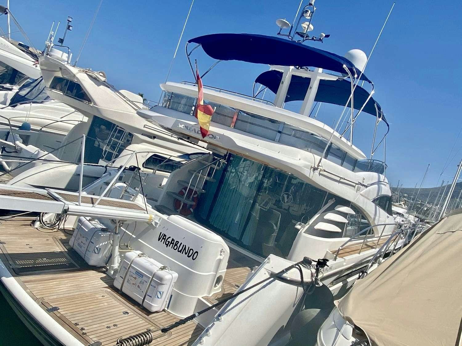 a boat docked at a pier aboard VAGABUNDO Yacht for Charter