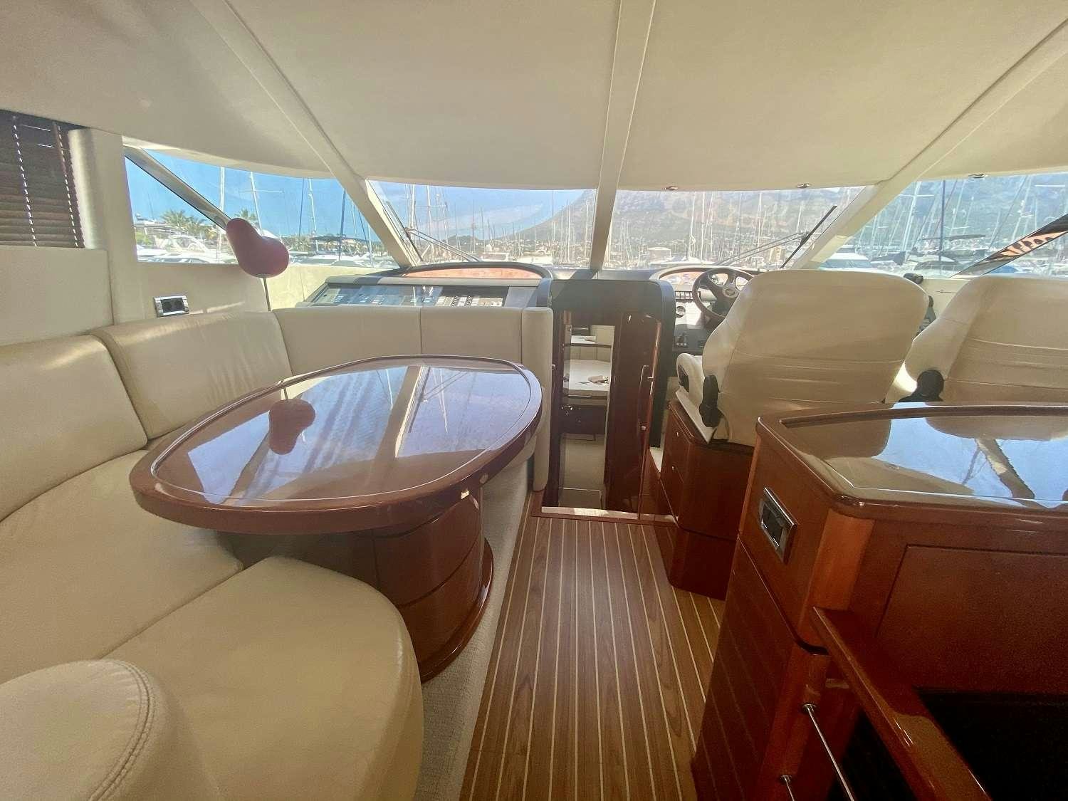 a boat with a table and chairs aboard VAGABUNDO Yacht for Charter