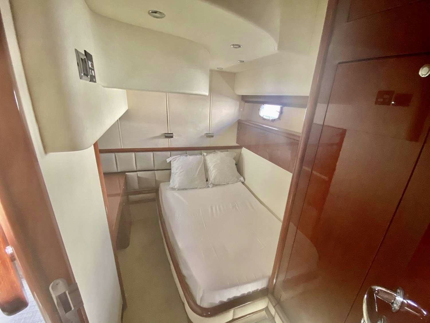 a room with a bed and a mirror aboard VAGABUNDO Yacht for Charter
