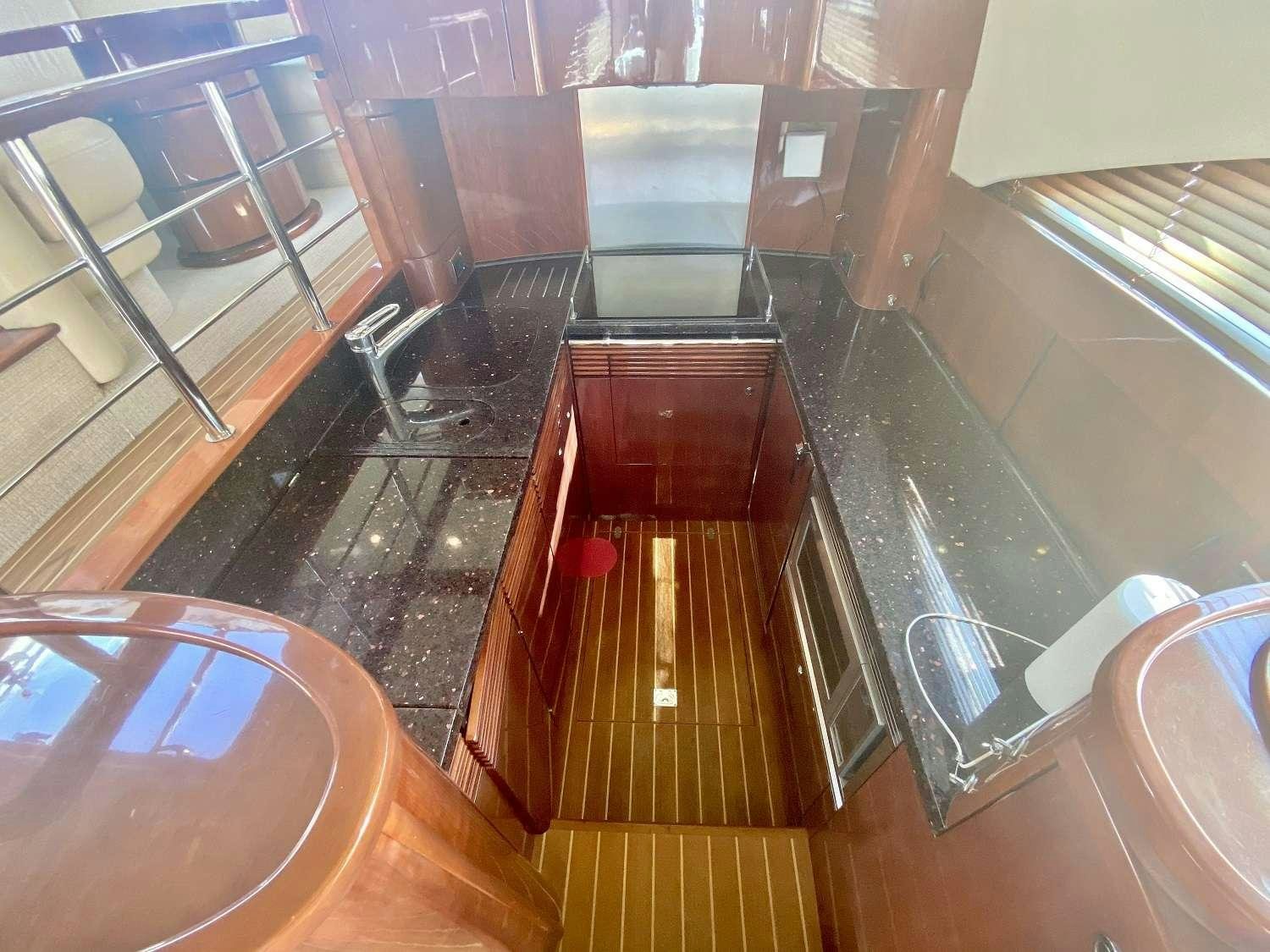 a kitchen with a wood floor aboard VAGABUNDO Yacht for Charter