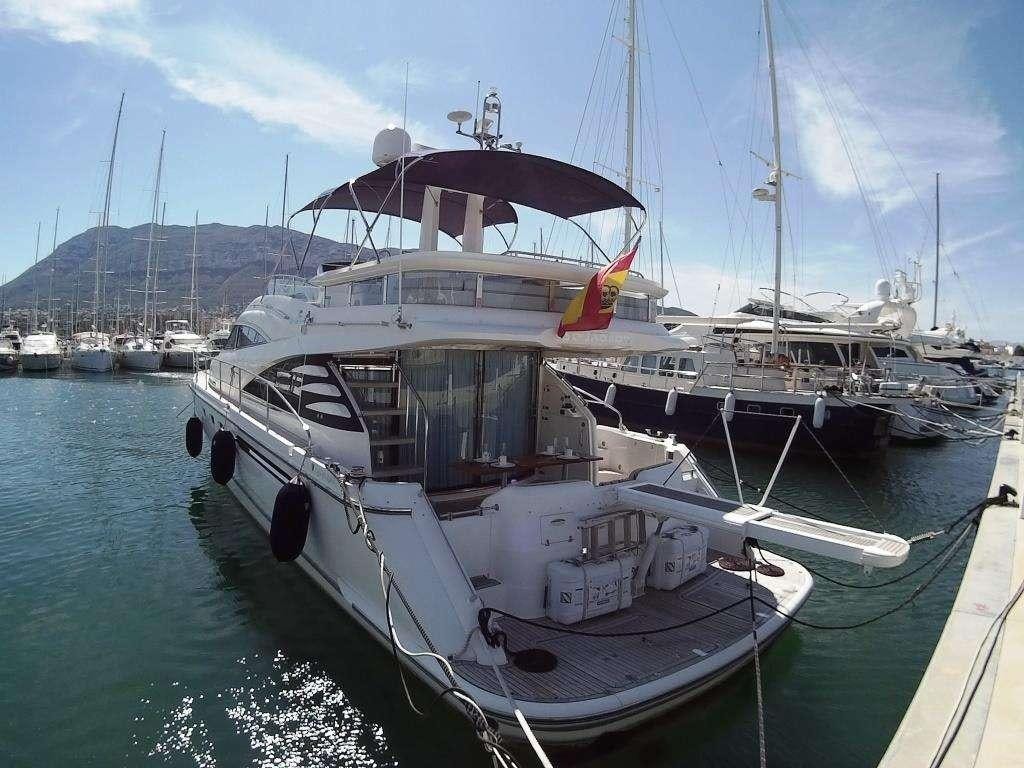 a boat docked at a pier aboard VAGABUNDO Yacht for Charter