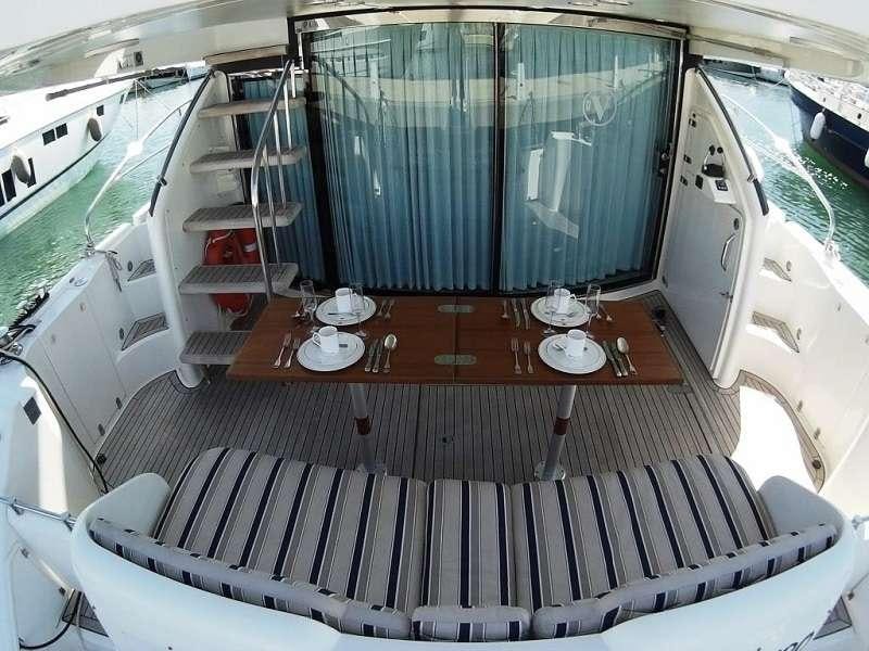 a boat with a table and chairs aboard VAGABUNDO Yacht for Charter