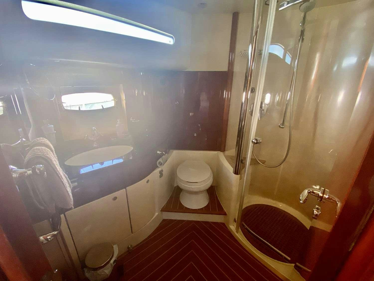 a bathroom with a tub toilet and sink aboard VAGABUNDO Yacht for Charter