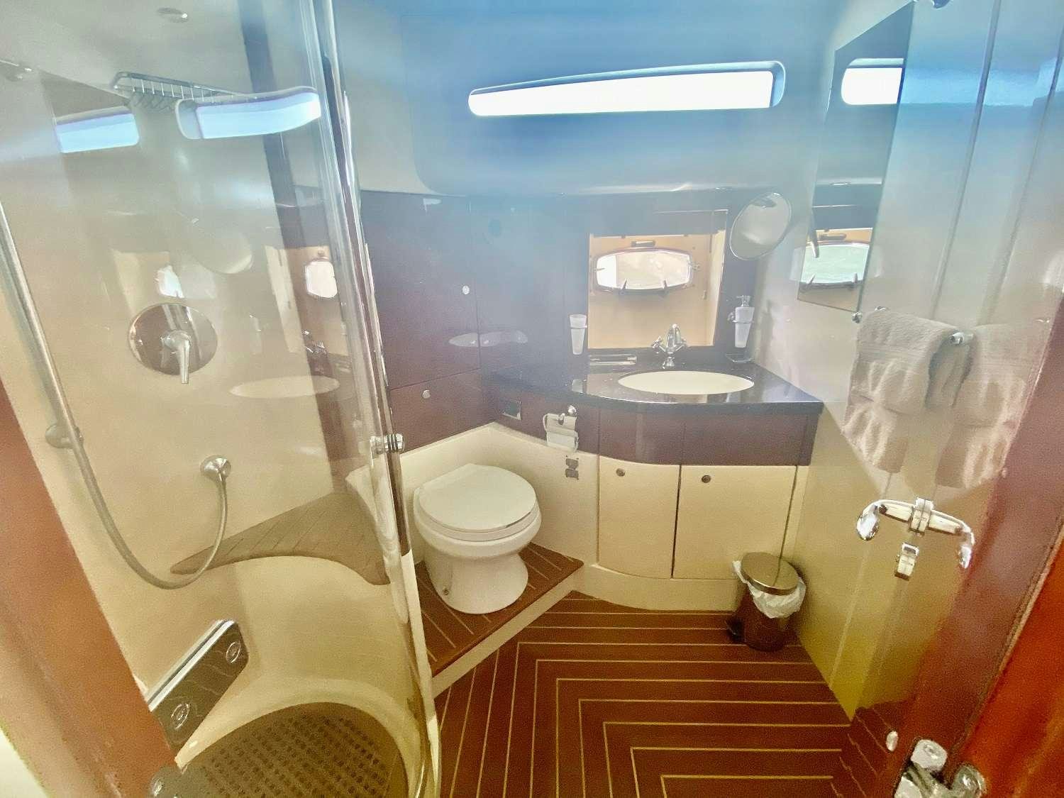 a bathroom with a glass shower aboard VAGABUNDO Yacht for Charter