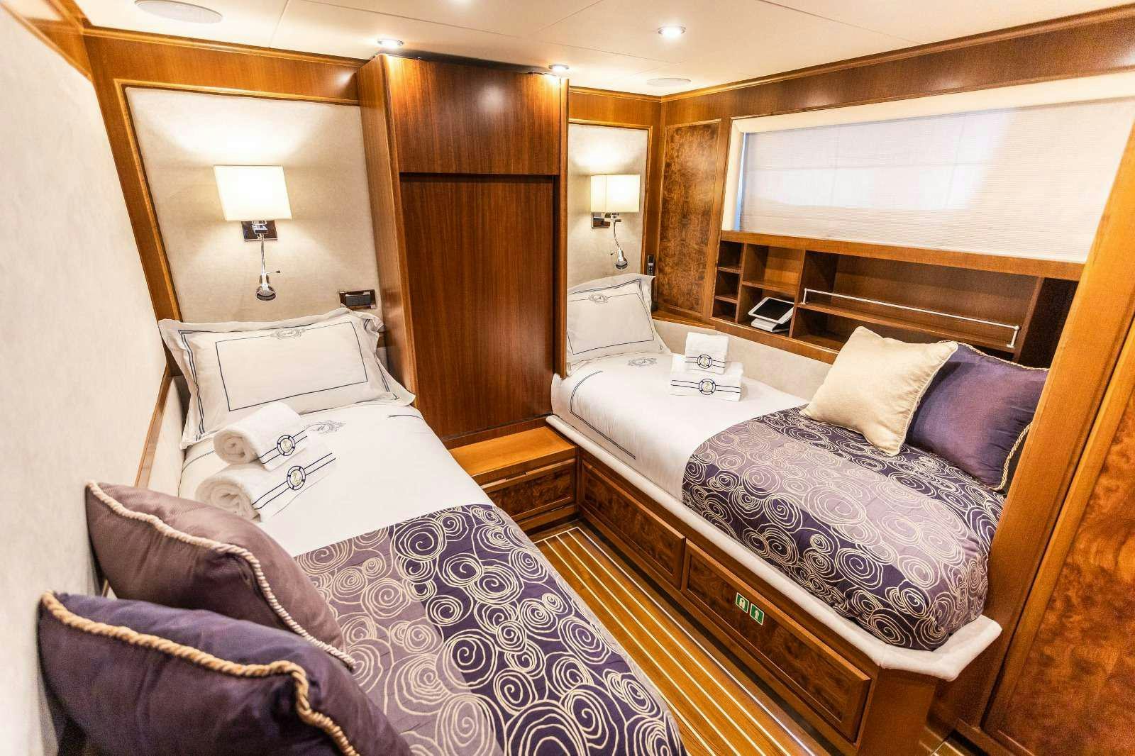 a bedroom with a bed and a couch aboard MILAYA Yacht for Charter