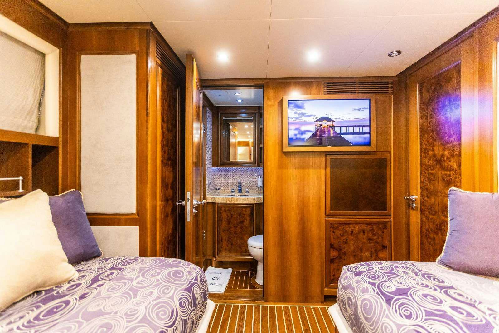 a bedroom with a tv on the wall aboard MILAYA Yacht for Charter