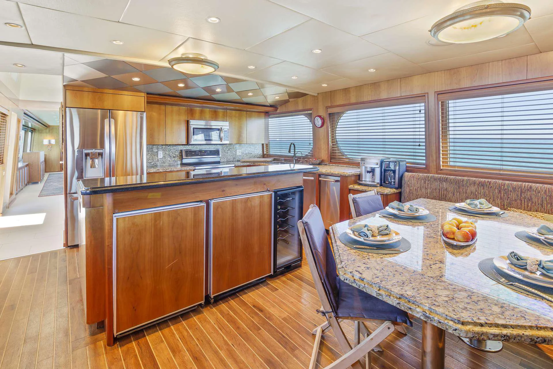 a kitchen with a table and chairs aboard IL CAPO Yacht for Charter