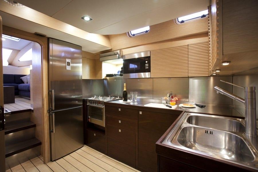 a kitchen with a stainless steel sink aboard WIZARD Yacht for Charter