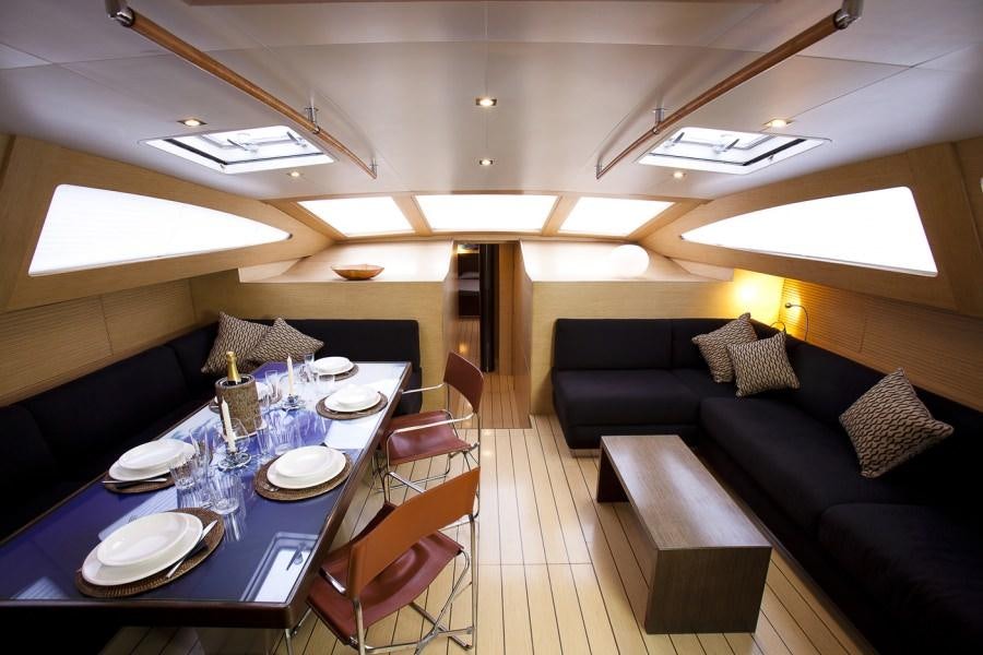 a room with a couch and a table and chairs aboard WIZARD Yacht for Charter