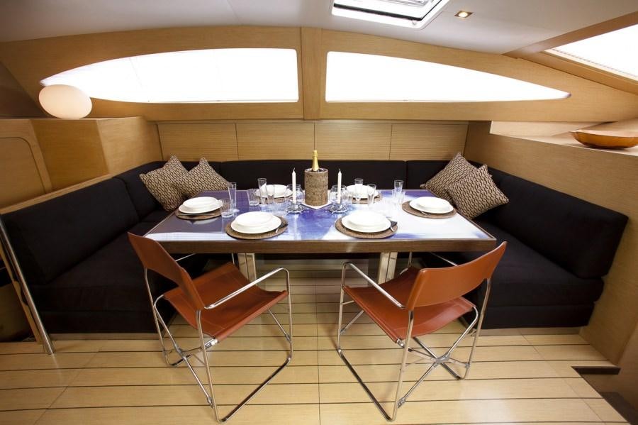 a dining table with a candle on it aboard WIZARD Yacht for Charter