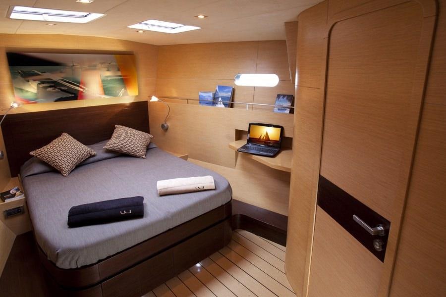 a room with a bed and a desk aboard WIZARD Yacht for Charter