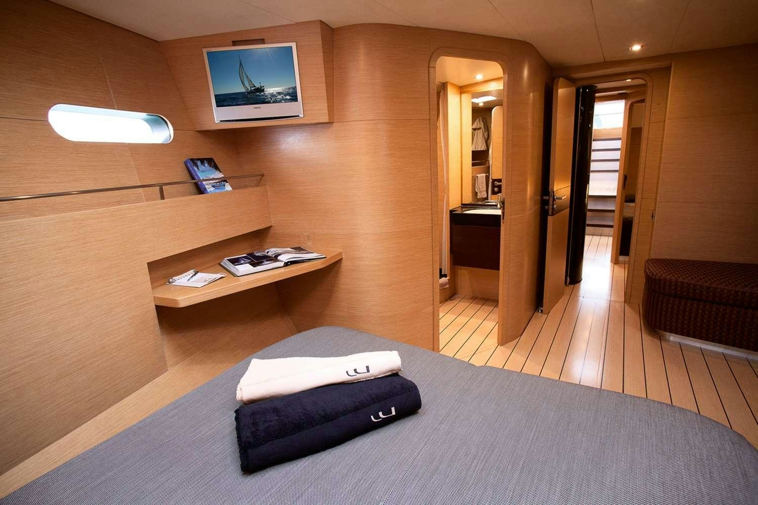 a room with a bed and desk aboard WIZARD Yacht for Charter